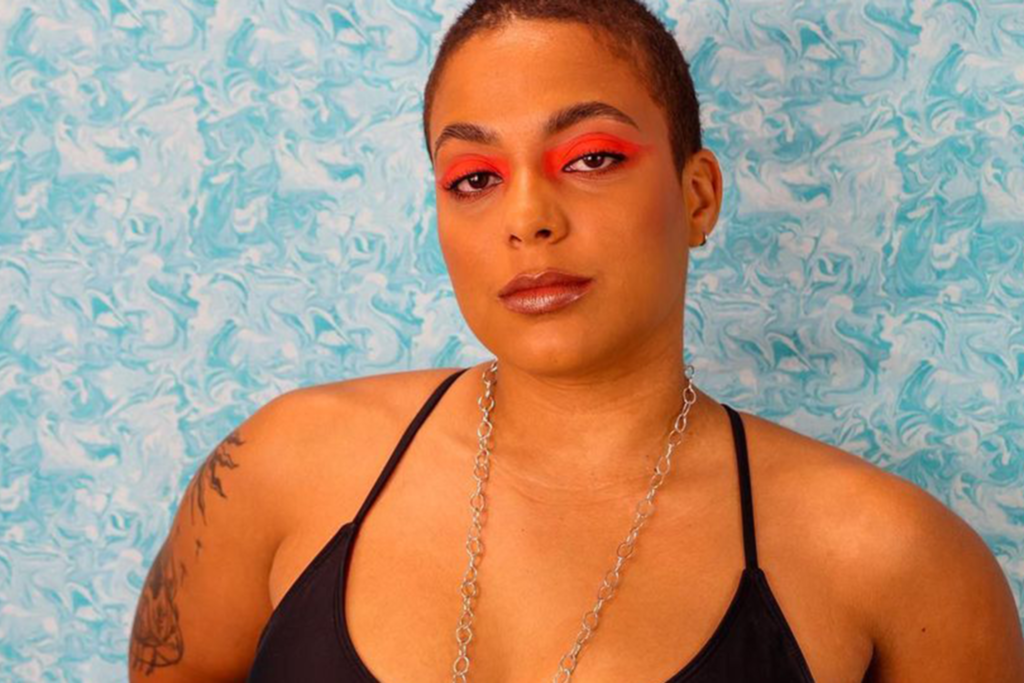 kia Washington for moon seed jewels in pink eyeshadow against a blue wall