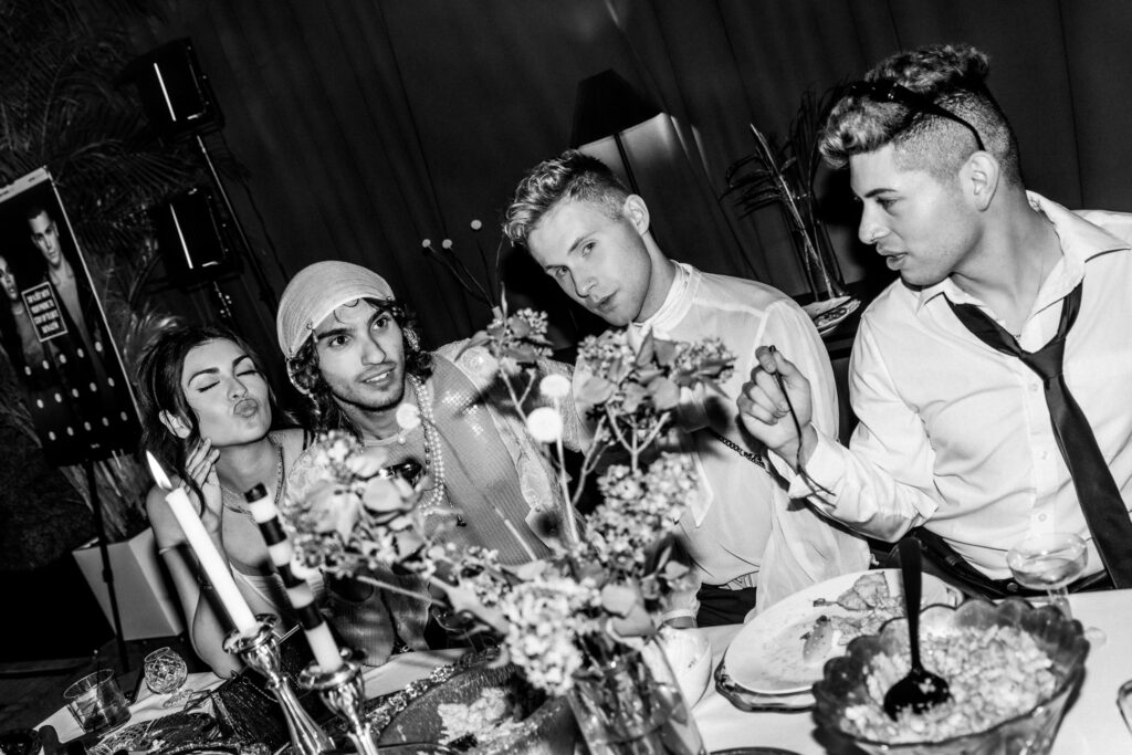 fashionable guests posing at a stylish dinner table at fashion industry night in scottsdale hosted by arizona fashion week