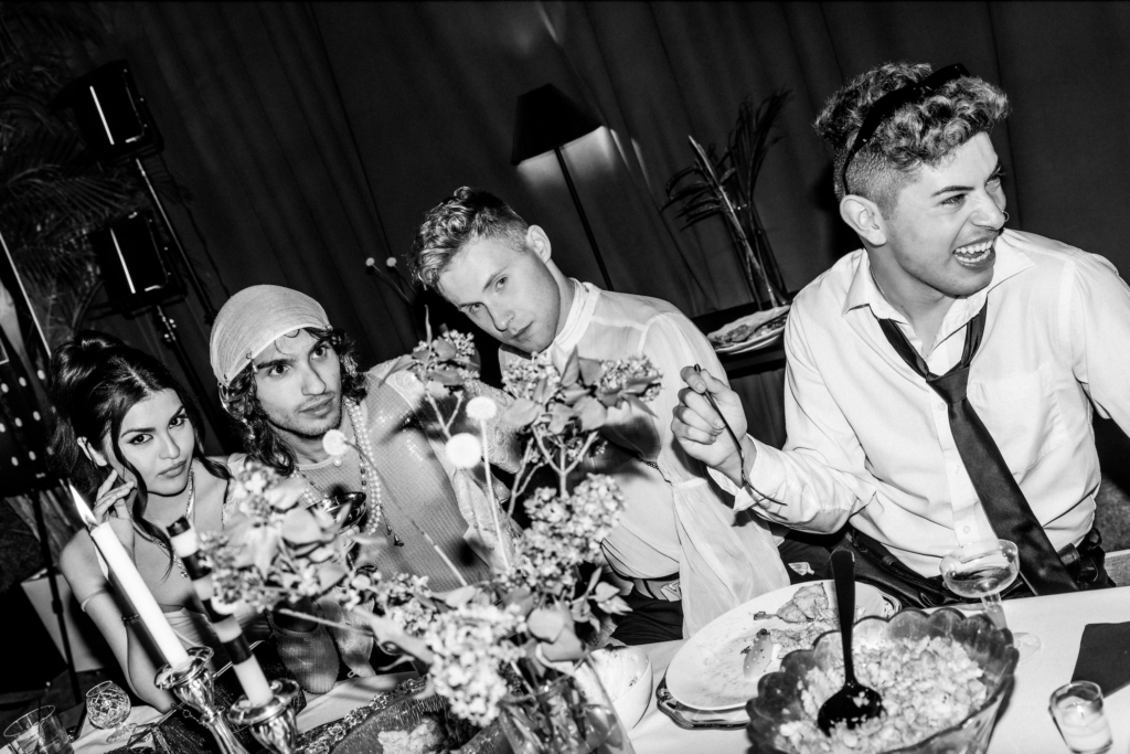 rocio Valenzuela, joseph leeds, kyle fedasiuk, and martin silva sitting at an extravagant dining table of door and decor in a photo by Jeff Otto create at fashion industry night in scottsdale